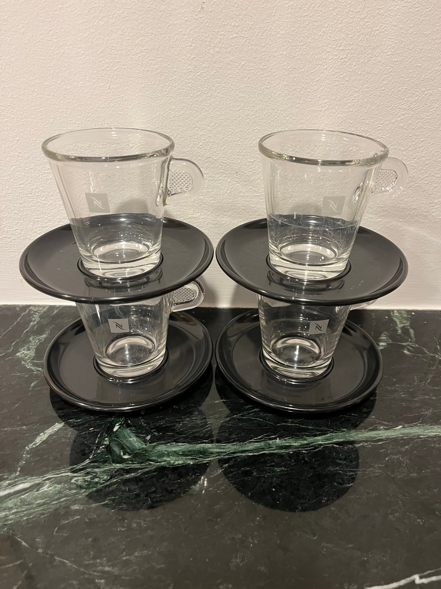 Set Of 4 Nespresso Glass Cups And Plastic Black Saucers 8764