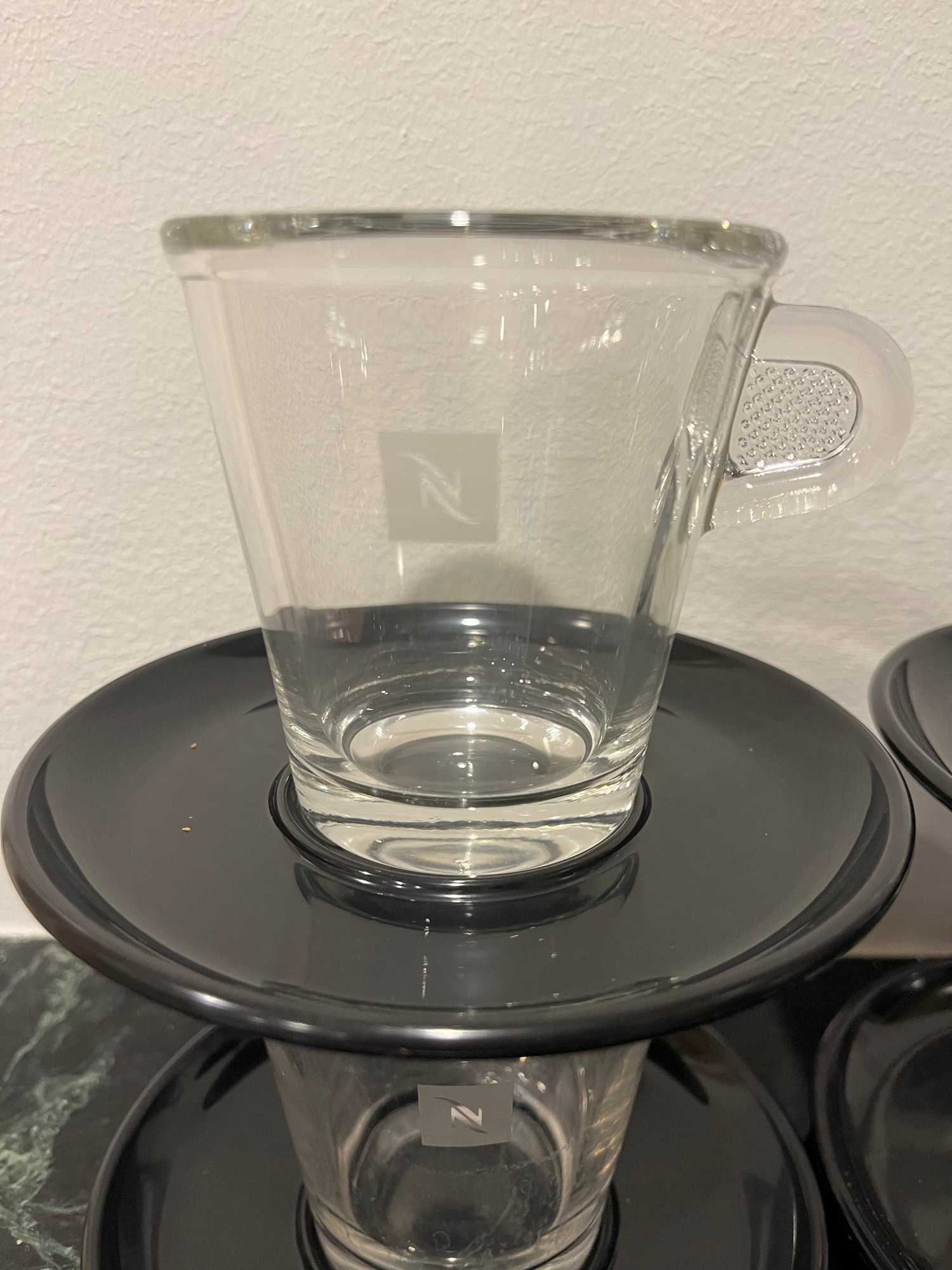 Set Of 4 Nespresso Glass Cups And Plastic Black Saucers 8764