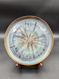 Decorative Ceramic Plate Featuring A Unique Glaze Pattern