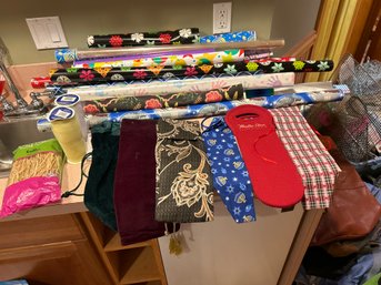 Large Assortment Of Wrapping Paper With Gift Wrapping Material And An Assortment Of Wine Bottle Sleeves