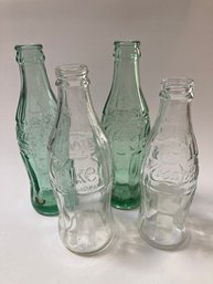 Four Coca Cola Bottles