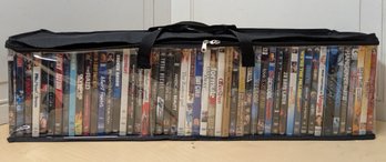 About 50 DVDs In Carrying Case Featuring Underworld, Office Space, Hangover III