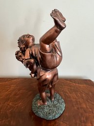 Sculpture Depicts Two Boys Playing, Rendered In A Bronze-colored Resin