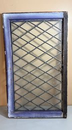 Vintage Glass Window Featuring A Diamond-Shaped Pane Pattern