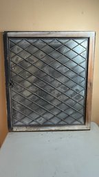Vintage Glass Window Featuring A Diamond-Shaped Pane Pattern