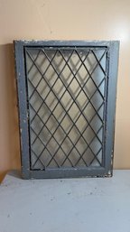Vintage Glass Window Featuring A Diamond-shaped Pane Pattern