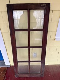 Vintage  Wooden Cabinet Door Featuring Glass Panels Arranged In A Grid Pattern