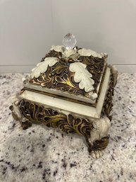 Old World-style Trinket Box With A Gold Finish And Decorative Elements.