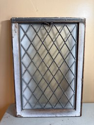 Vintage Glass Window Featuring A Diamond-shaped Pane Pattern