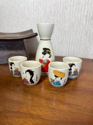 Vintage Japanese Porcelain Sake Set Featuring A Geisha Design