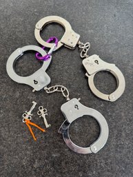 A Pair Of Handcuffs With Keys