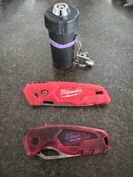 Two Milwaukee Knives And A Locking Pill Case