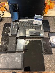 Lot Of Used Phones, Computers, And A Calculator
