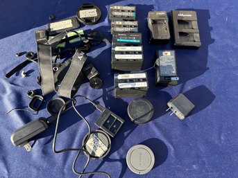 A Collection Of Batteries And Camera Parts