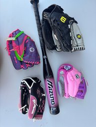 A Collection Of Gloves, A Bat, And Some Balls