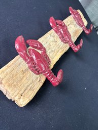 Decorative Wall-mounted Lobster Hook, Made Of Cast Iron, Attached To A Piece Of Driftwood.