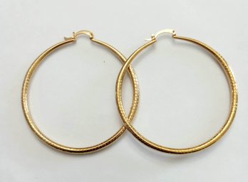 BRAND NEW PAIR OF GOLD FILLED HOOP EARRINGS. MEASURES 2 1/2 X 2 1/2''