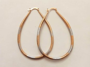 BRAND NEW PAIR OF GOLD AND SILVER FILLED OVAL HOOP EARRINGS. MEASURES 2 1/4 X 3 1/2''