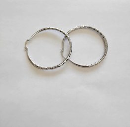 BRAND NEW PAIR OF SILVER FILLED HOOP EARRINGS. MEASURES 2 1/2 X 2 1/2''