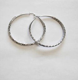 BRAND NEW PAIR OF SILVER FILLED HOOP EARRINGS. MEASURES 2 1/2 X 2 1/2''