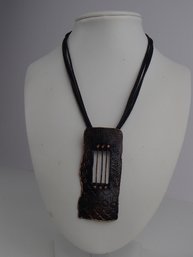 Corded Necklace With Artisan Metal Pendant