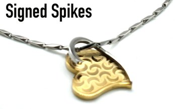 Lot 821LC -  Two-tone Heart Pendant Signed Spikes Stainless Steel And Segmented Chain