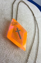 Lot 353LC - 1970s Cross On Irridescent Orange Pink Clear Diamond Shape Acrylic Lucite Pendant - Goldtone Chain