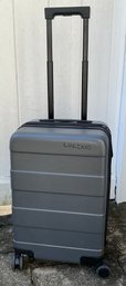 Lot 65- Made By Design Grey Small Carry On Rolling Suitcase