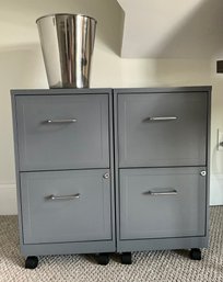 Lot 90- Pair Of Grey Metal Filing Cabinets With Key On Wheels & Chrome Trash Barrel - Office Supplies