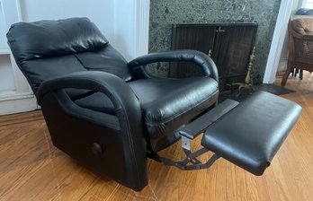 Black Faux-leather Manual Recliner With Padded Curved Armrests And An Extended Footrest
