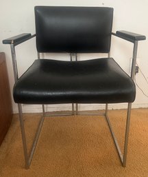 Mid-Century Modern Classic Armchair Featuring Black Faux Leather And Sleek Steel Cantilever Frame
