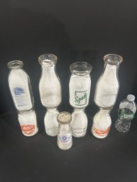 Lot 230- Nine Milk Bottles