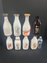 Lot 233- Eight Milk Bottles