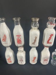 Lot 234- Eight Milk Bottles
