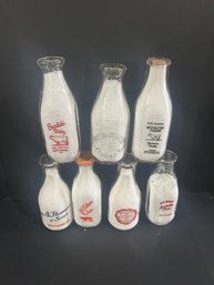 Lot 235- Seven Milk Bottles