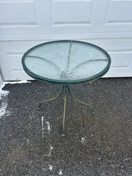 Lot 294- Round Green Metal Patio Table With Textured Glass Top