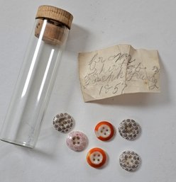 As Found - A Glass Tube With 1857 Buttons And A Note