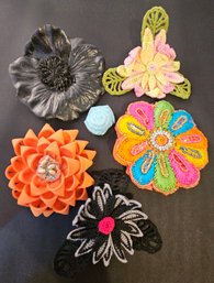 An Assortment Cute Handmade Flower Pins And Coin Purse In Various Colors And Sizes