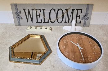 A Wooden Welcome Sign, Clock And Mirror
