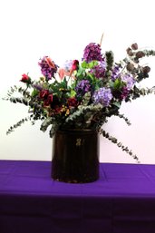 Crock With Floral Arrangement.