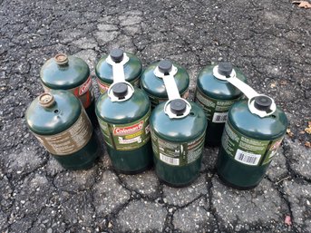 Eight Coleman Mini Propane Tanks