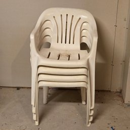 Four White Plastic Chairs