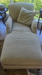 Beige Upholstered Chaise Lounge With Matching Pillow.