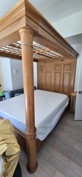 Solid Wood Canopy Bed With Detailed Panel Headboard And Turned Posts.