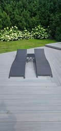 Set Of Two Black Wicker Outdoor Chaise Lounge Chairs With Matching Small Side Table.