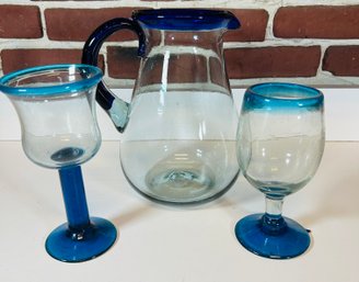 Glass Pitcher With Blue Rim And Two Goblets