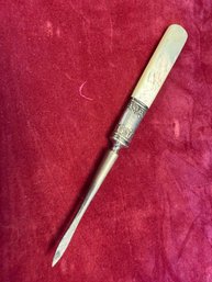 Antique Flatware Piece Featuring A Carved Mother Of Pearl Or Bone Handle With An Ornate Sterling Silver Collar