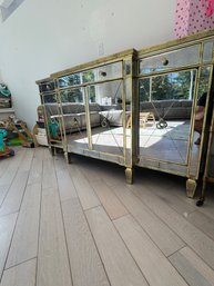 Elegant Mirrored Sideboard With Gold Trim And Decorative Hardware.