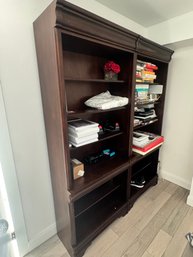 Large Wooden Bookcases With Multiple Shelves And Decorative Molding.
