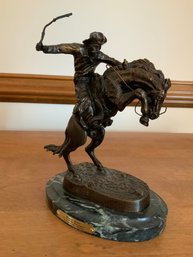 Bronze Reproduction Sculpture Of Frederic Remingtons Famous Bronco Buster Cowboy On Horse